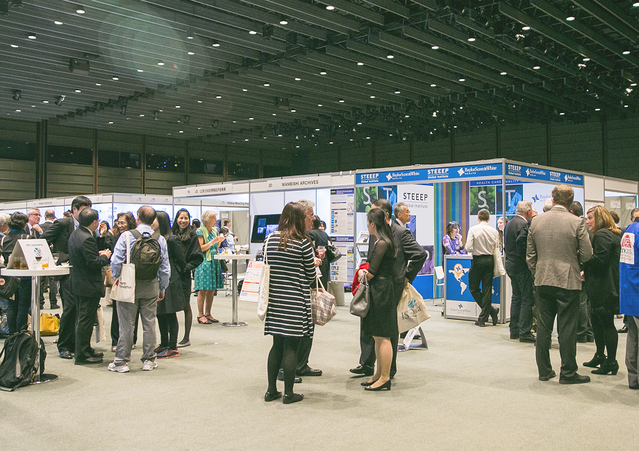 Crowded healthcare exhibition hall with various booths like STEEEP and HIMSS UK Archives, capturing active networking and professional engagement.